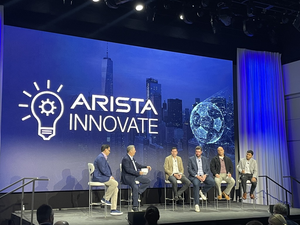 The fireside chat panel on stage at Arista Innovate NYC